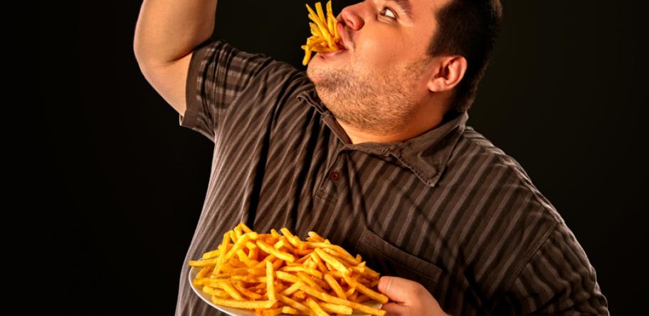fat man eating junk food