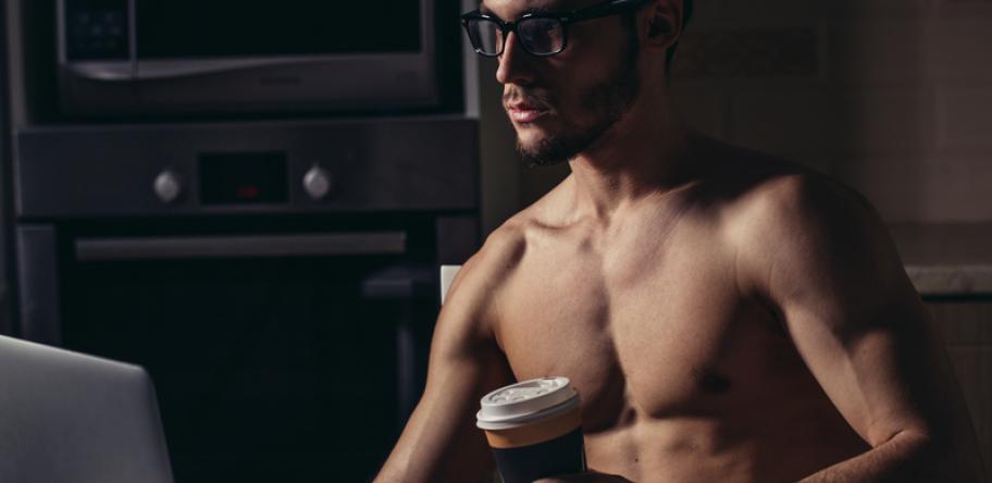 fit man at computer with coffee