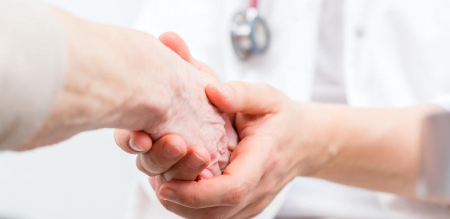 patient and doctor holding hands
