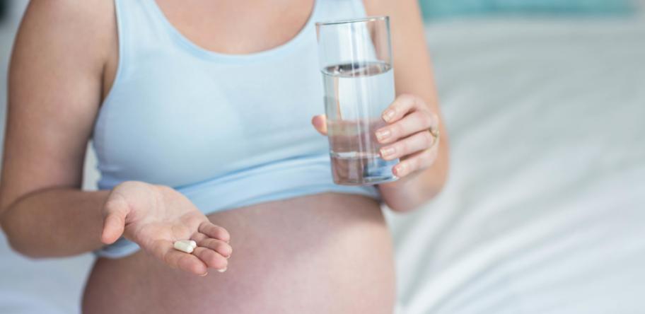 pregnant woman with pill