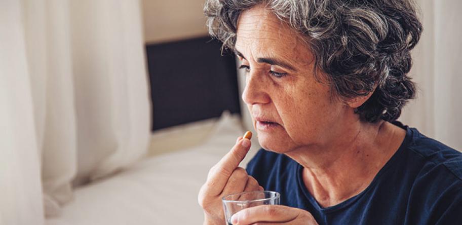 senior woman taking pill