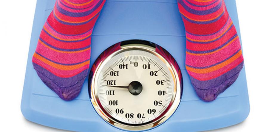 teenager on scales