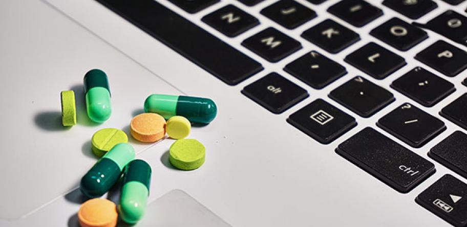 pills next to laptop