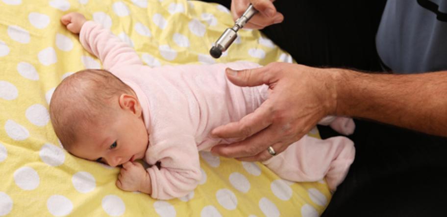 Chiro treating baby